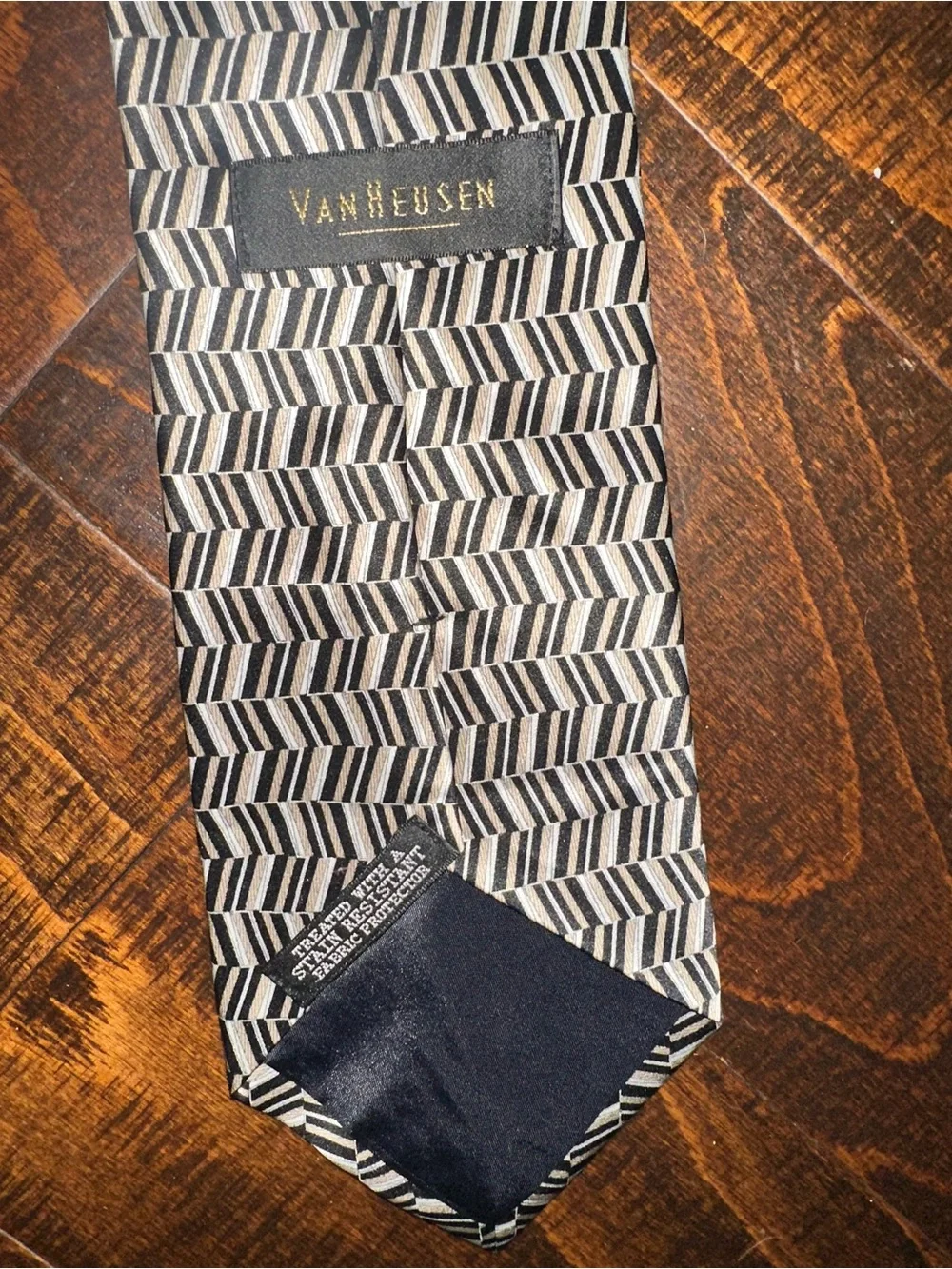 VAN Heusen necktie features black, beige, and grey geometric herringbone pattern